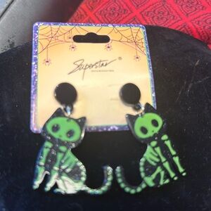 Halloween earrings new with tags. Cute black cat with green skeletal. Pierced.​